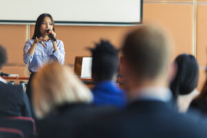 A presenter interacting with the audience at a business presentation in the board room